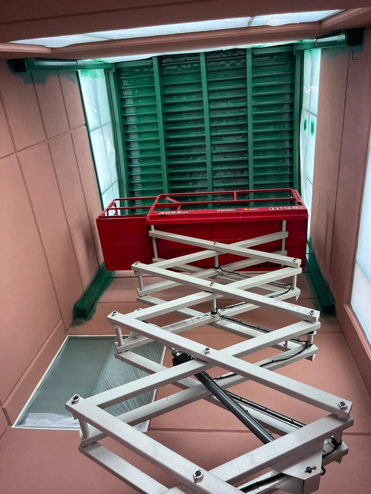 Scissor lift equipment staged for a commercial spray painting job