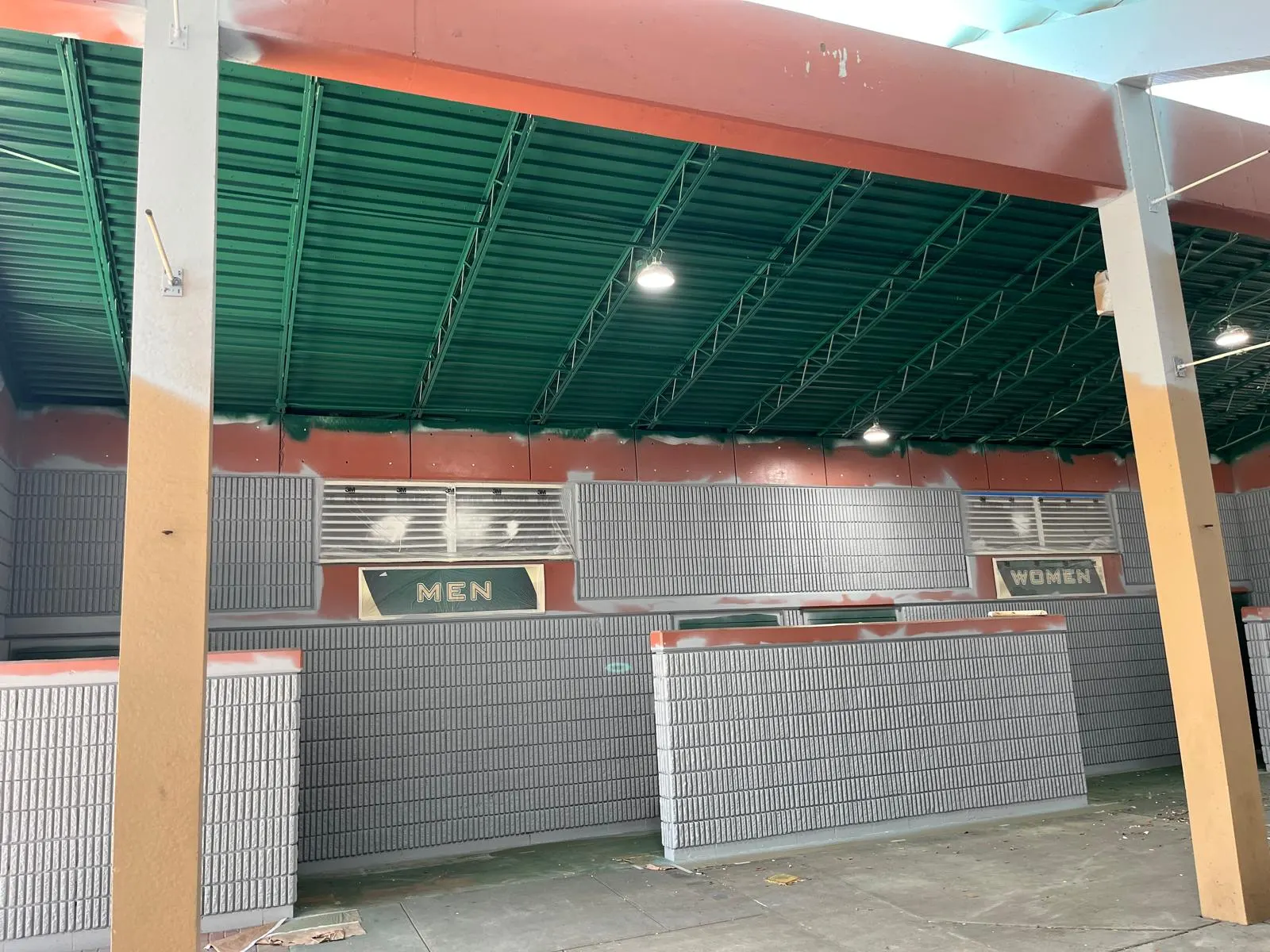 Painted restroom building with block walls and a green ceiling