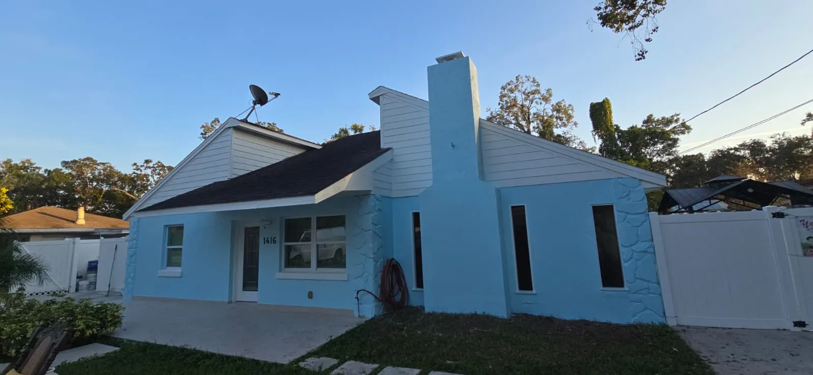 Freshly painted light blue home exterior in Holiday, FL