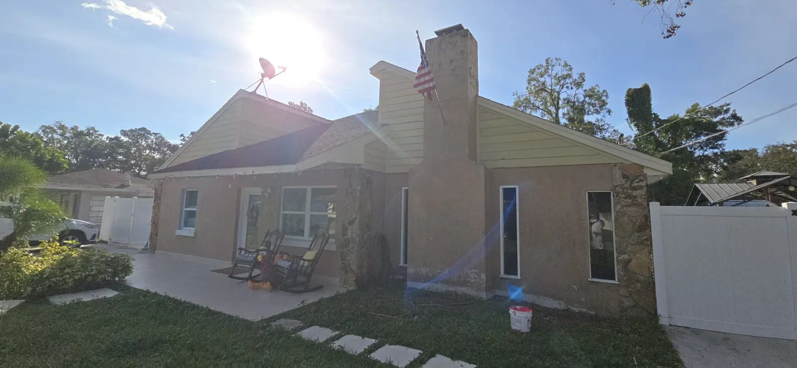 Tan stucco home exterior before repainting