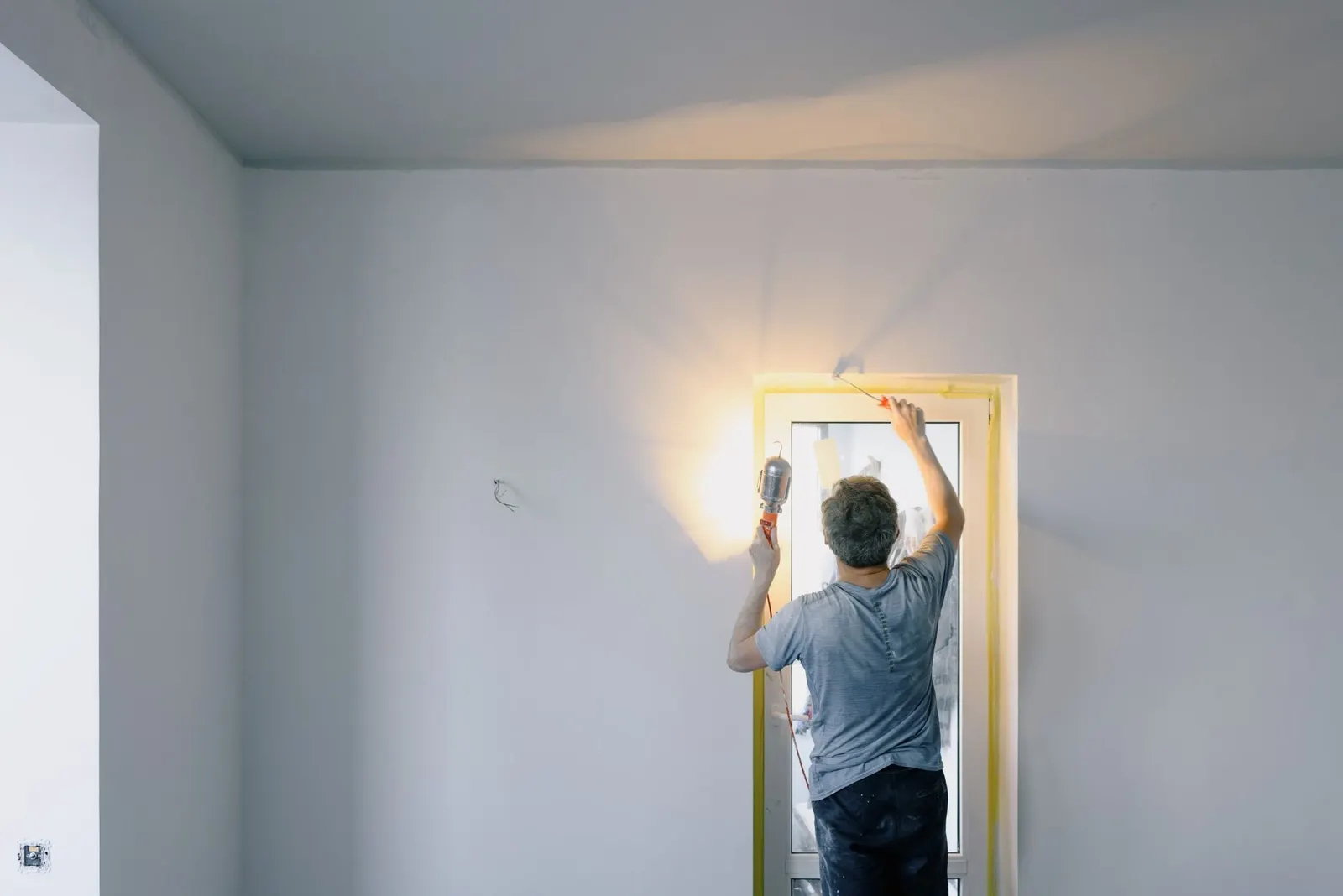 Handyman repairing a door in a Tampa Bay home